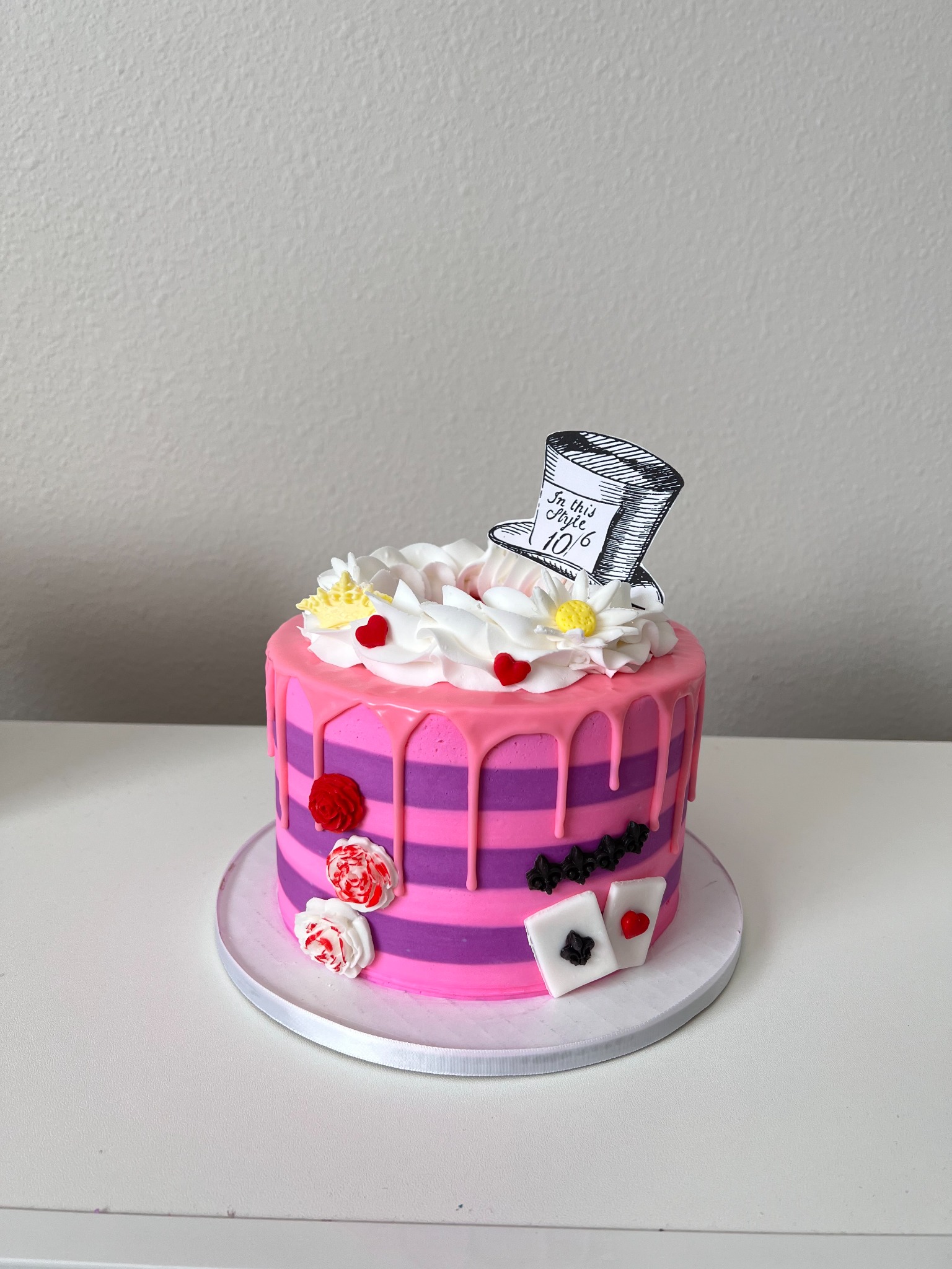 Alice in Wonderland inspired pink striped drip cake