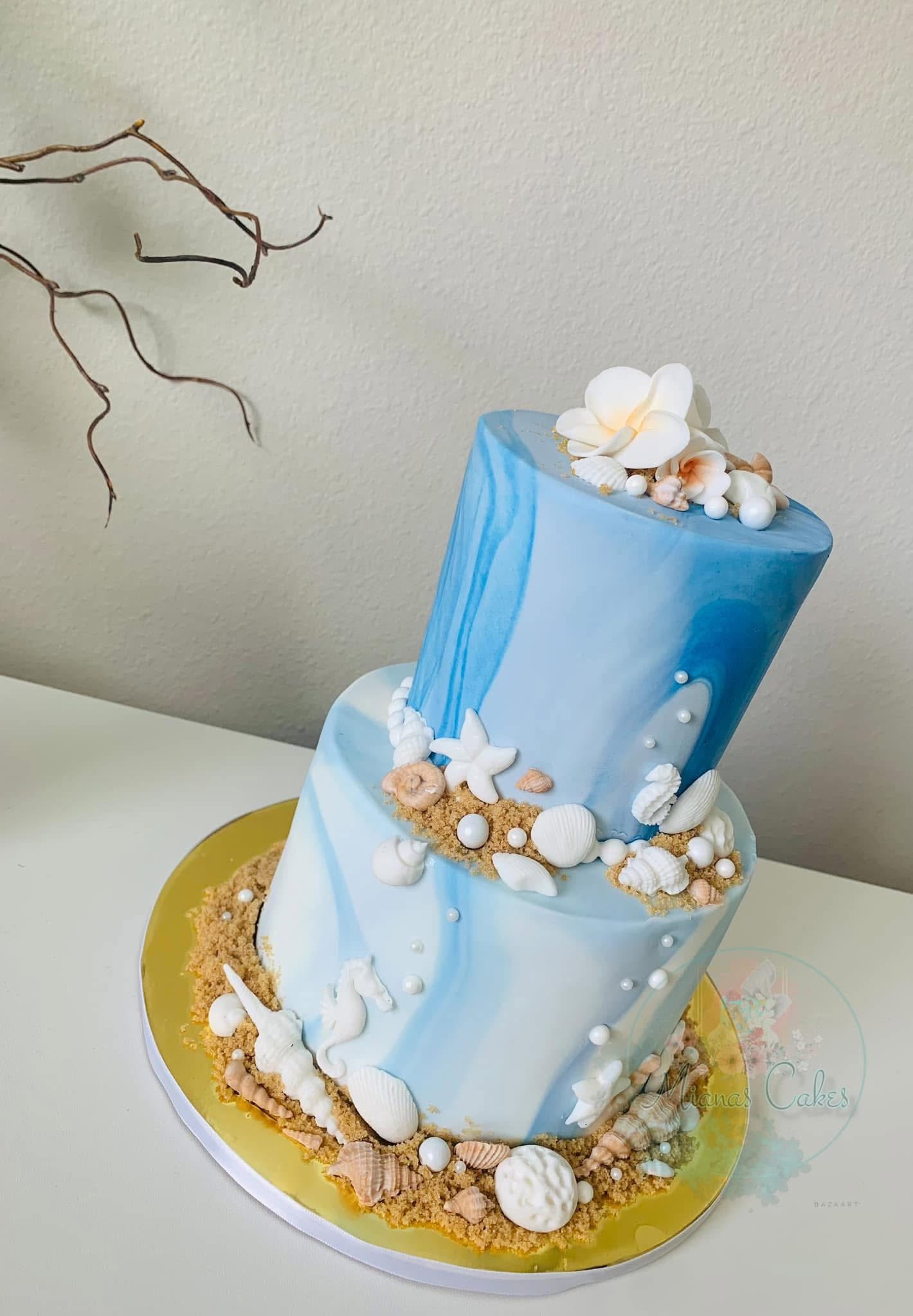 Blue beach themed tiered cake with shells