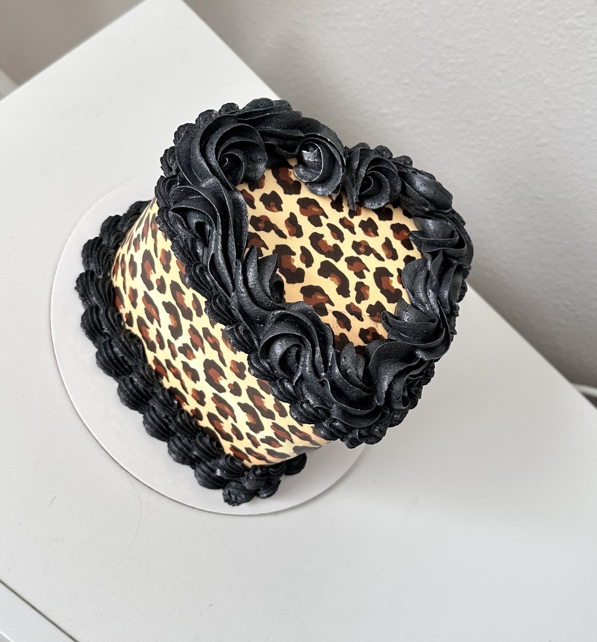 Leopard print cake with black rosettes