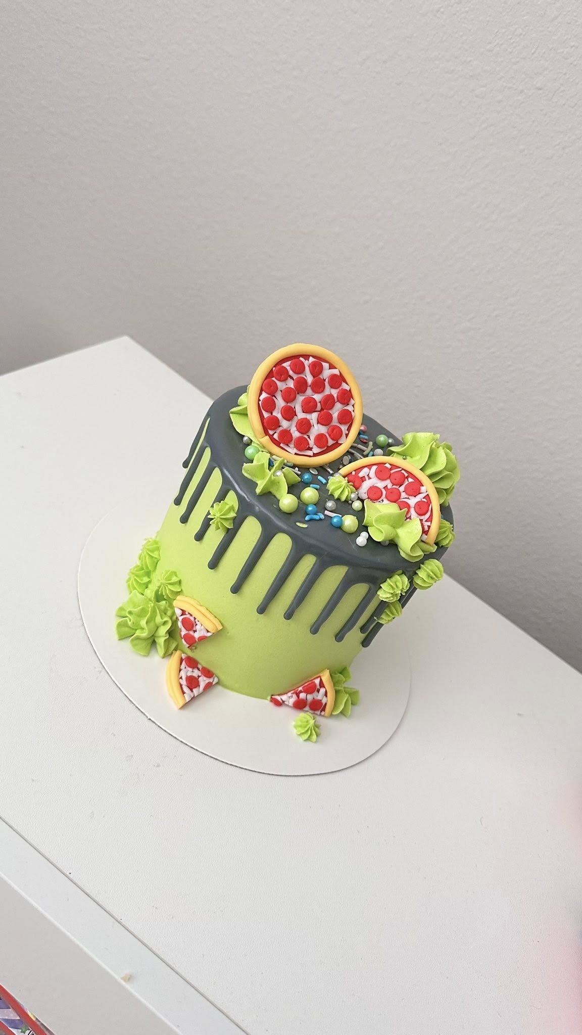 Green and gray pizza themed drip cake