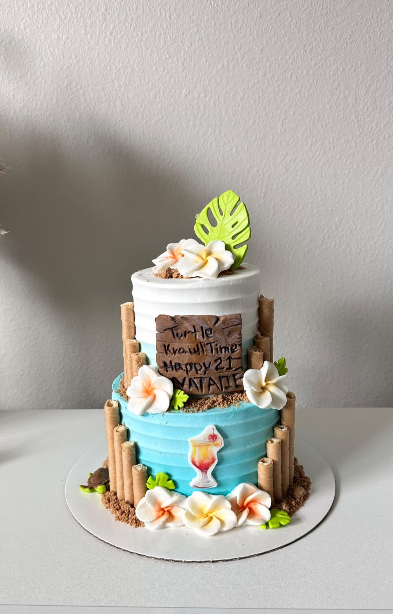 Tropical tiered cake with flowers and tiki details